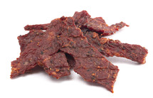 A Pile of Black Pepper Beef Jerky on a White Background