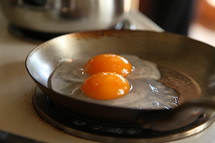 Eggs in a skillet on a stove.