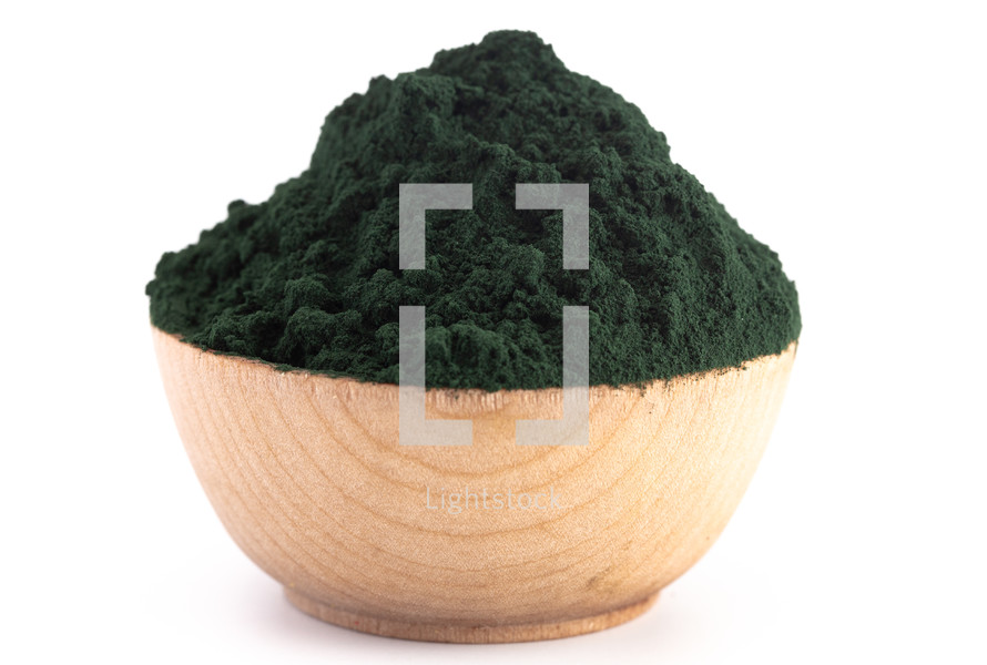 A Wooden Bowl Full of Spirulina Powder on a White Background