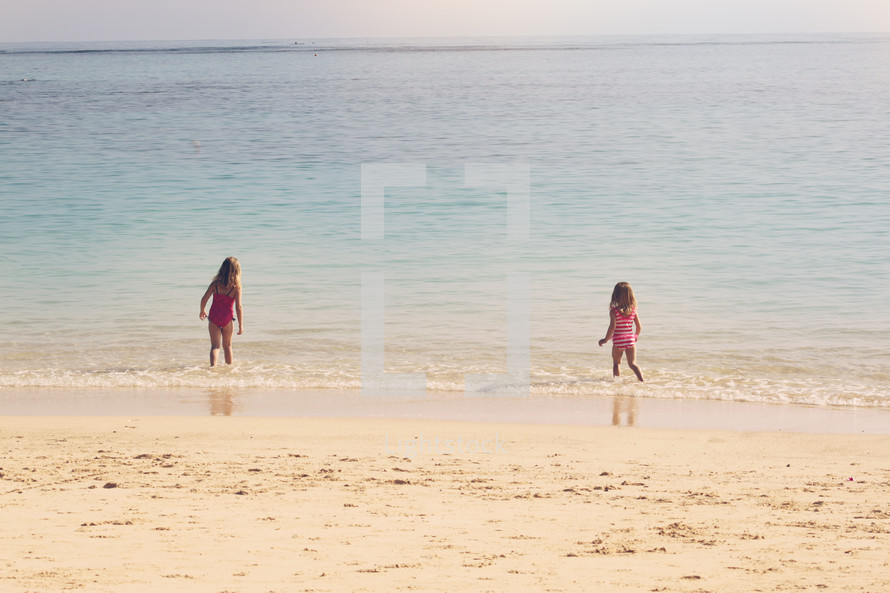 girls running on a beach 