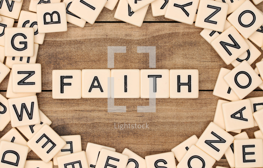 scrabble pieces and the word faith 