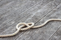 knot in rope on a wood background 