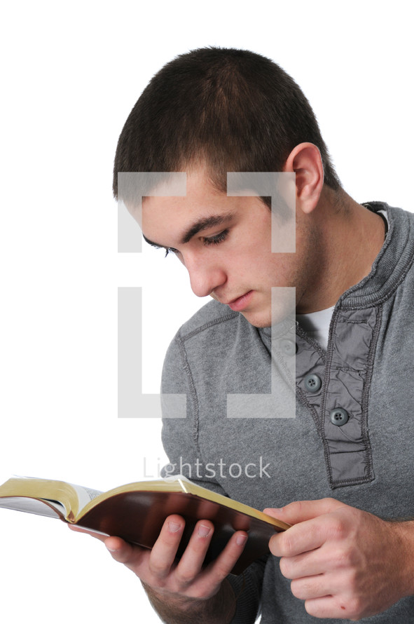 teen boy reading a Bible