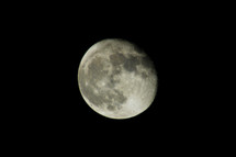 A near full moon on a clear dark night