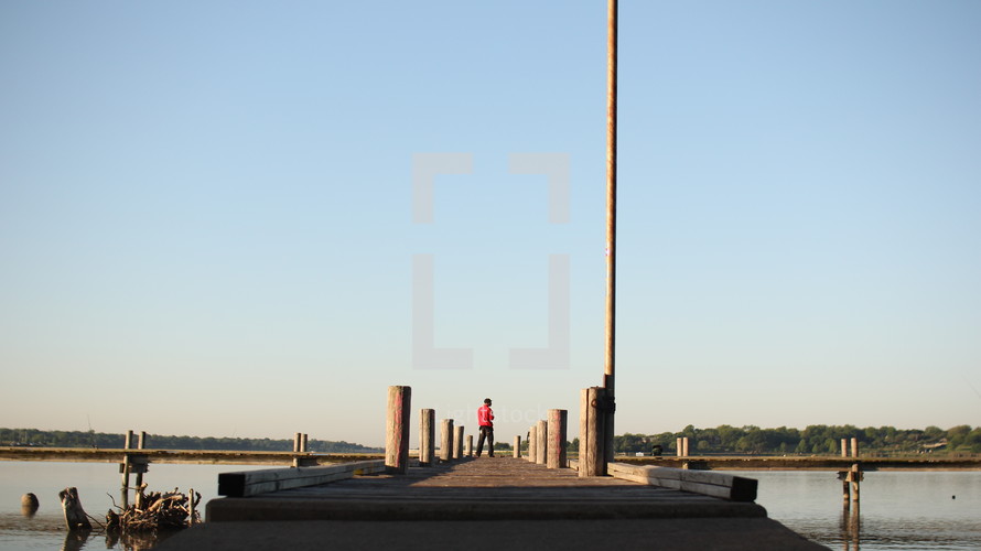 a man standing on a pier 