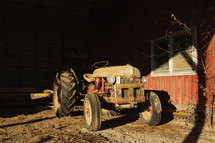 Red, vintage tractor in a barn