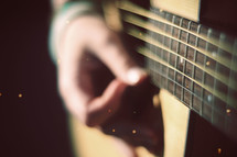 hand on guitar strings 