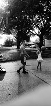 kids playing basketball in their driveway 