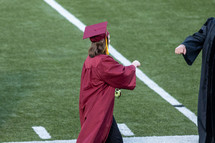 graduate giving a fist bump 
