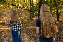 girls walking through the woods 