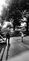 kids playing basketball in a driveway 