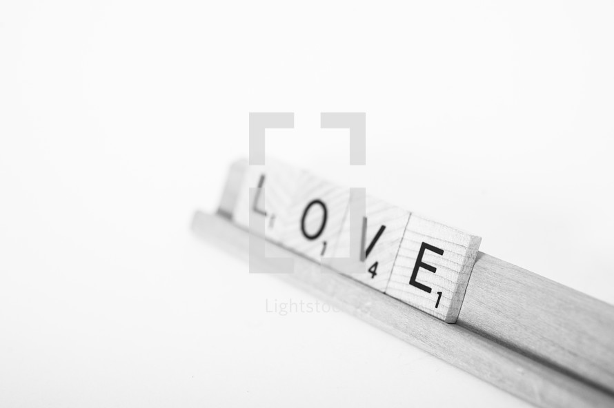 Scrabble tiles spelling "love."