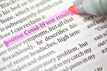 A Highlighter Marker on newspaper News about coronavirus disease COVID 19