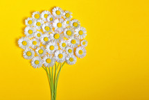 Abstract daisy flower bouquet on yellow background