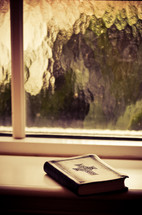 bible sitting in a window sill