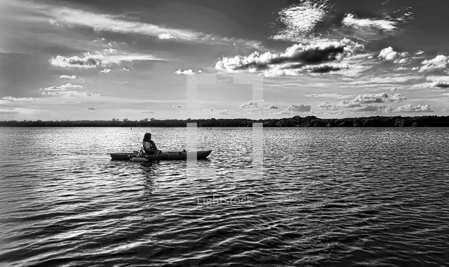 on a kayak in black and white 