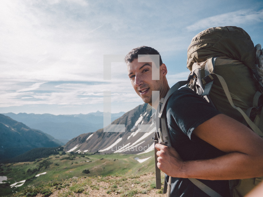 man hiking a mountain trail 