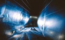 a man standing in a tunnel at night 