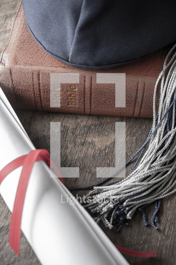 graduation cap, diploma, and Bible 