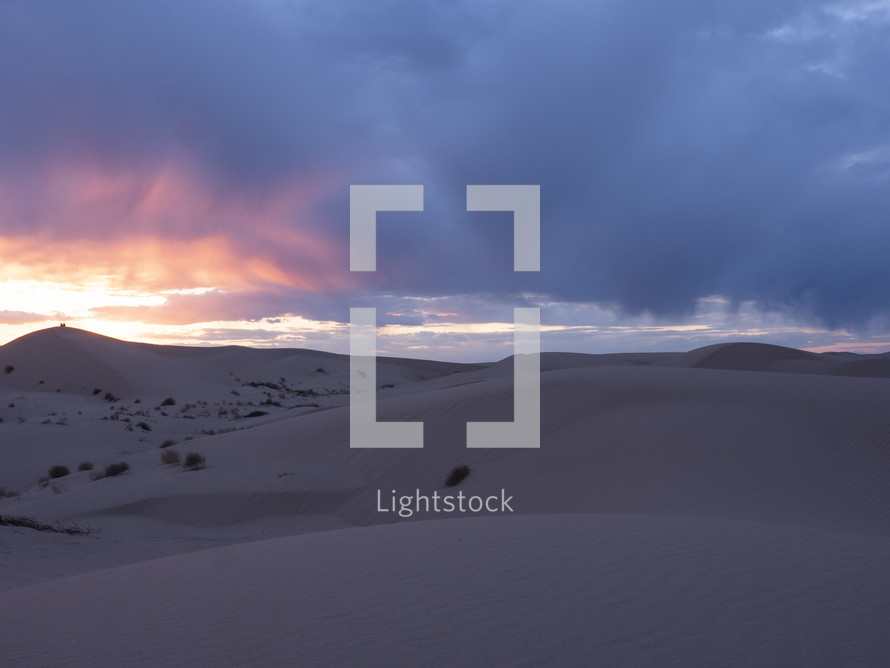 Sand dunes in the desert at sunset