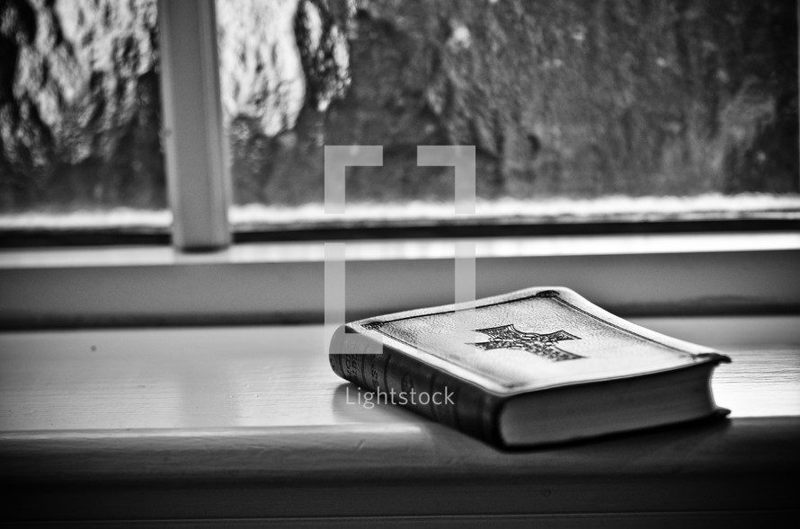bible resting in a window sill 