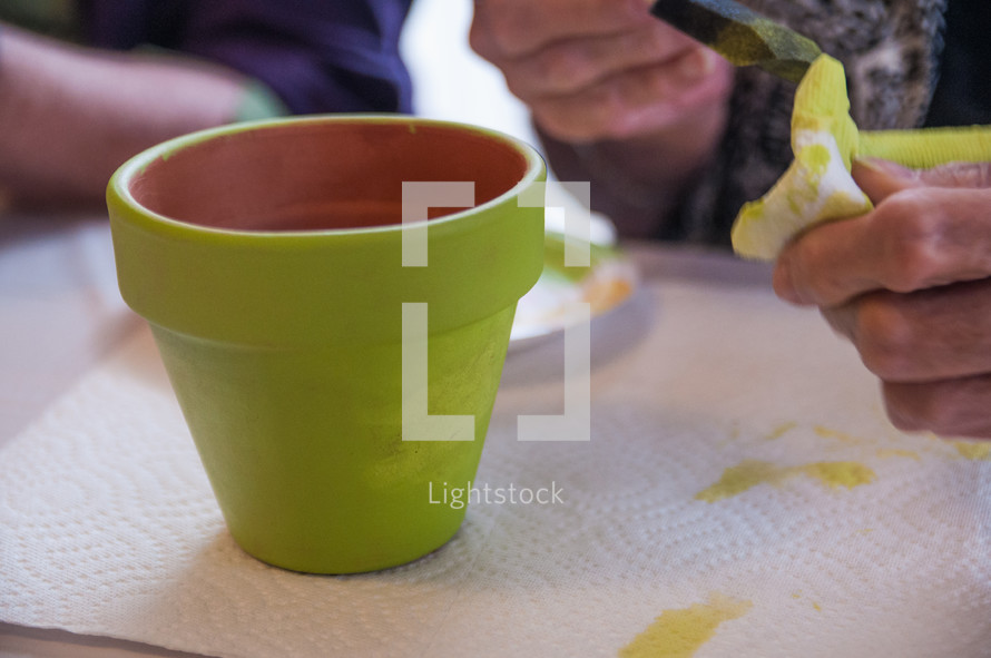 Painting a terracotta pot.
