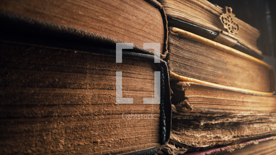 Old books in antique shop or abandoned library. Macro footage. Bookstore in vintage style. Literature, knowledge, information concept. High quality