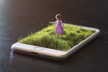 a child playing outdoors - image on an iPhone screen 