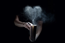 opening a dusty book and a cloud of dust in the shape of a heart 