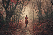 Woman walking through the misty woods.