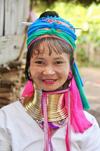 a woman with gold rings around her neck 