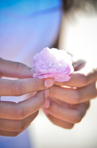 girl holding a pink flower