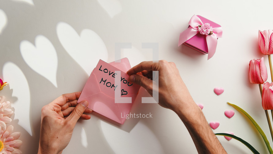 Mother's Day note with pink flowers and gift