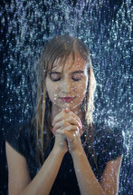 a woman praying in the rain 
