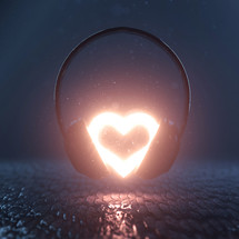 A bright glowing heart in the middle of a pair of headphones
