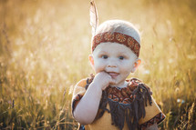 Happy Cute Smiling Little Boy dressed in Native American Apache Clothes 