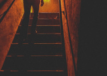 woman walking up stairs in the dark