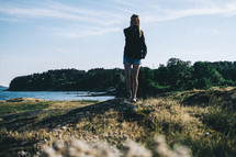 a woman standing on a shore in Sweden 