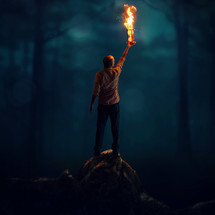 man holding up a flaming hourglass 