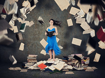 a woman surrounded by books 