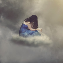 woman praying on a cloud. 