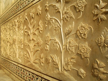 detailed carved flowers along a wall of the Taj mahal 