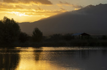A colorful sunrise over a peaceful mountain lake