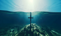 Cross in water. Christian cross underwater.