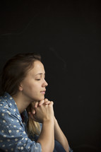 side profile of a woman in prayer 