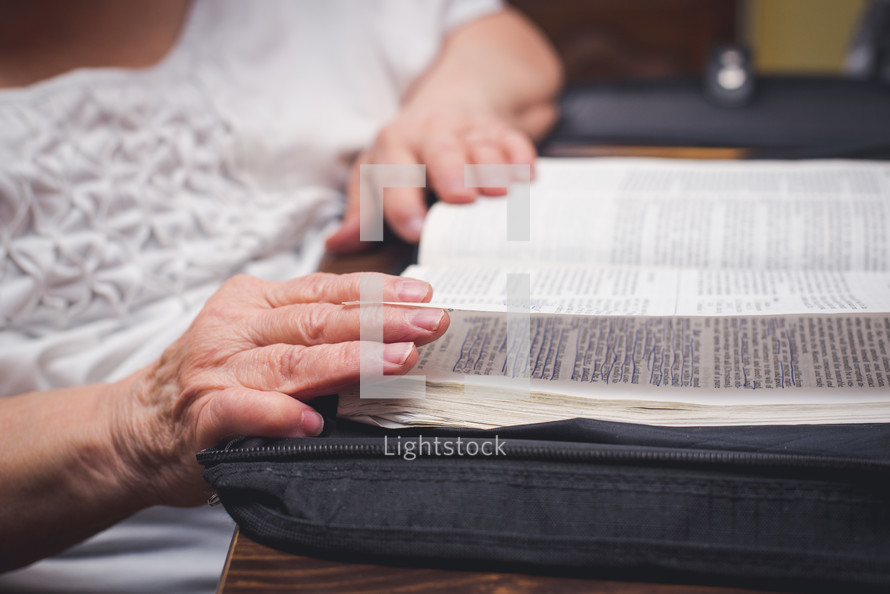 elderly woman reading a Bible 