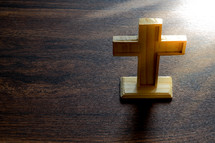 wooden cross on a wood table 