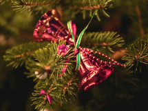 red bell ornaments on a Christmas tree