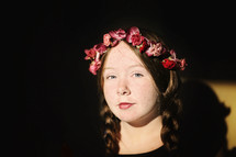 freckled face girl child with braid hair and crown of flowers 