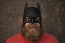 man with a beard in a batman mask 